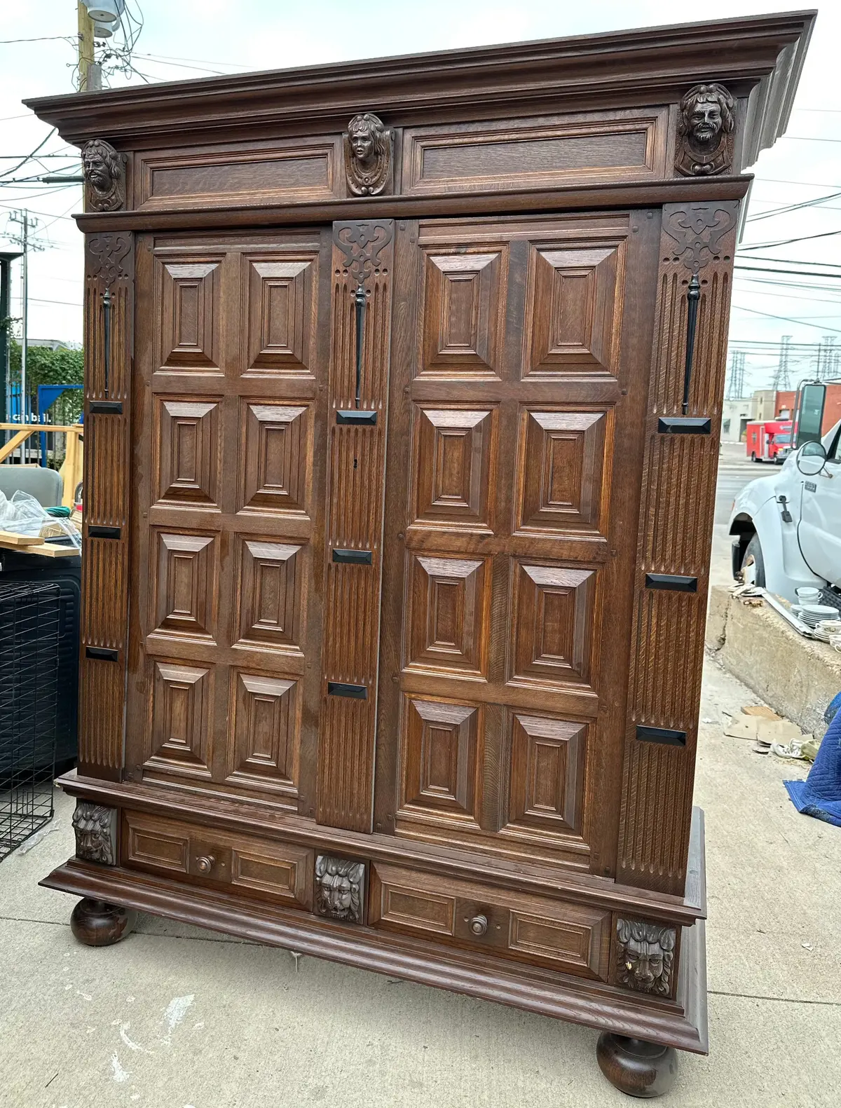 Oak Paneled Double Door Armoire With Carved Heads 1
