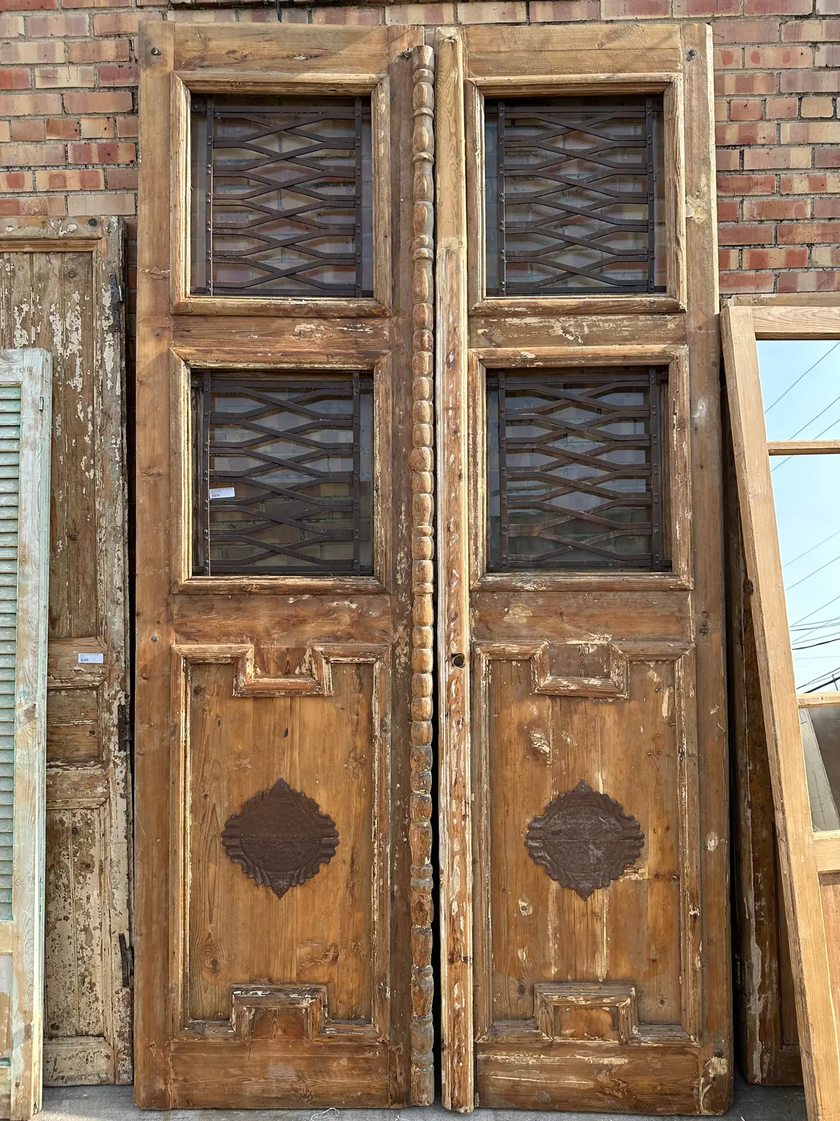 Pair Of Tall Egyptian Iron Inset Primitive Wood Doors With Iron Emblems 1