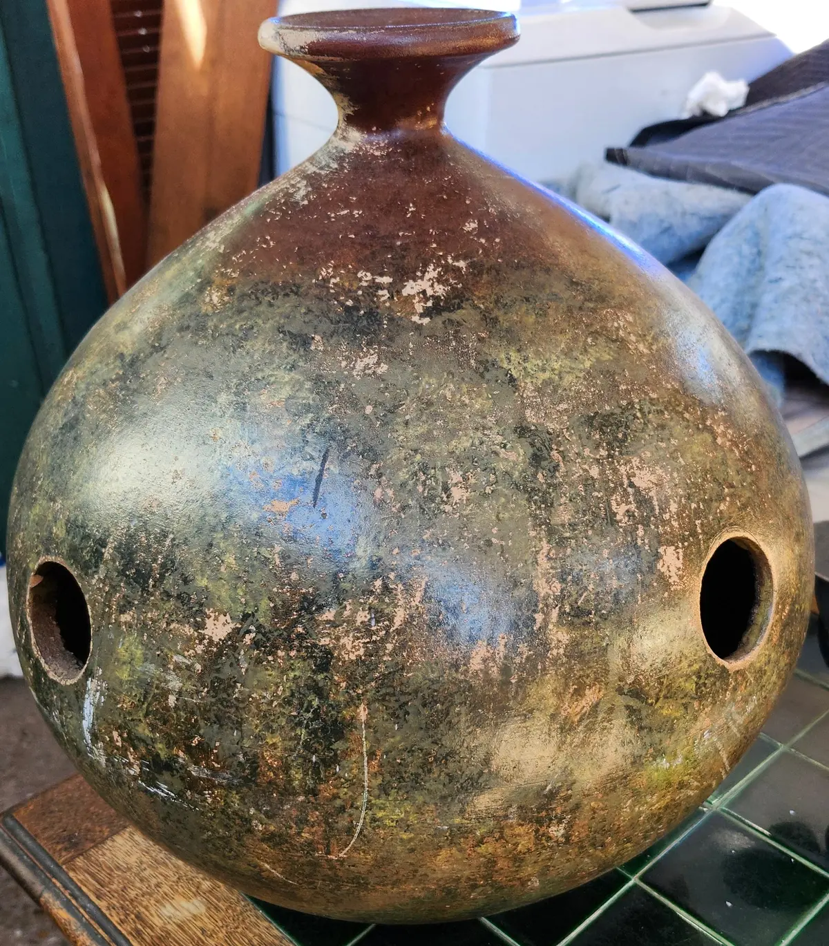 Large Brown Pottery Jug With Narrow Neck And Decorative Holes In Body 1
